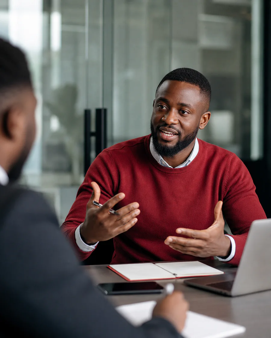 Black sales professional leading a consultative client conversation